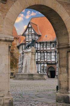 Lion statue and old timbered house in Braunschweig patio, Germany
