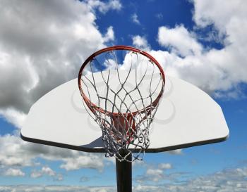basketball hoop against a blue sky
