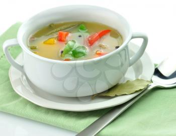 vegetable soup in a white soup cup 