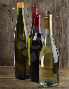 White And Red Wine Bottles On Wooden Background