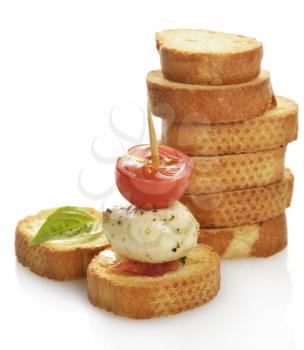 A Pile Of  Bread Rusks With Mozzarella Cheese And Tomatoes