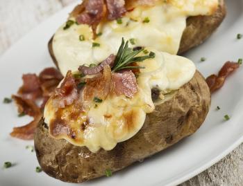 baked potatoes with bacon and cheese , close up