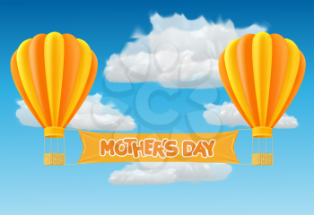 Yellow and orange air ballon with mother day banner fly past clouds