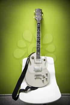 Electric guitar, green wall on the background