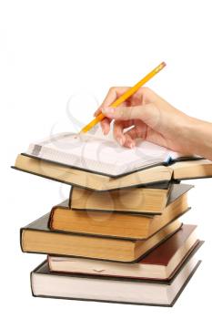 Books and hand with pencil on white