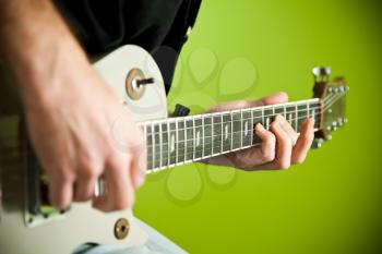 Close up of an electric guitar being played. 