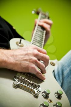Close up of an electric guitar being played. 