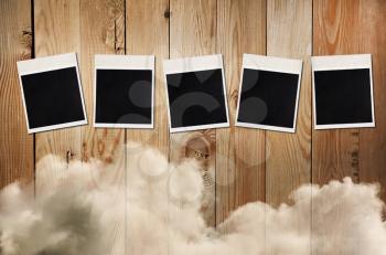 Old photos on a wooden background with clouds, free space for 5-letter word or photo