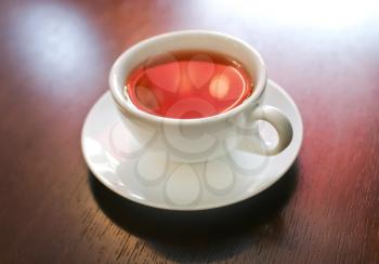Cup of tea on wooden table, macro