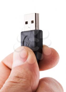 Fingers holding usb cable, isolated on white