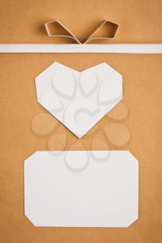 Hand made paper tag and heart on kraft paper as background. Greeting card