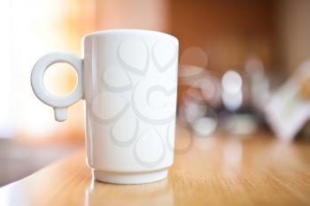 Cup of coffee or tea on wooden table, small dof