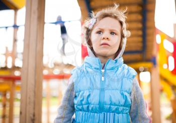 Pensive Little girl on playground area