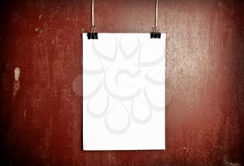 Blank white poster on a rope, metal background