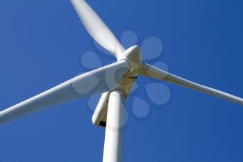 A wind turbine under clear blue sky