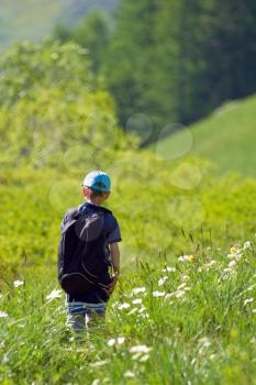 A young child walking in the meadow