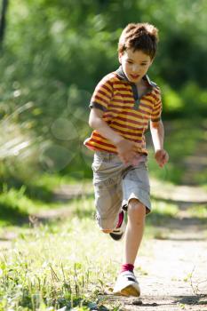 A young boy running in the nature