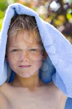 A young child in nature with towel