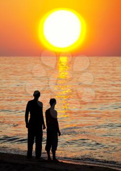 Royalty Free Photo of a Silhouette of Men on the Beach