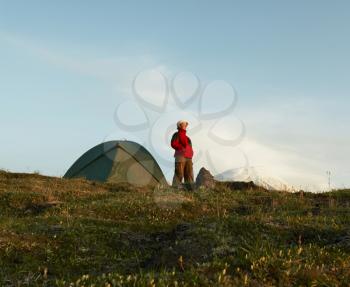 Royalty Free Photo of a Woman Standing Outside a Tent