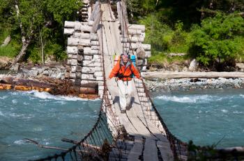 Royalty Free Photo of a Backpacker on a Bridge
