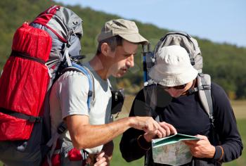 Royalty Free Photo of Men Looking at a Map on a Hike