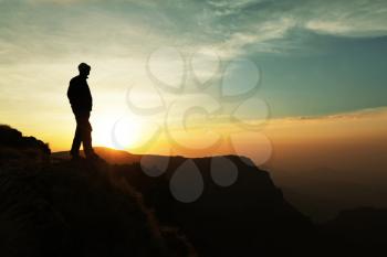 Royalty Free Photo of a Silhouette of a Man on a Cliff