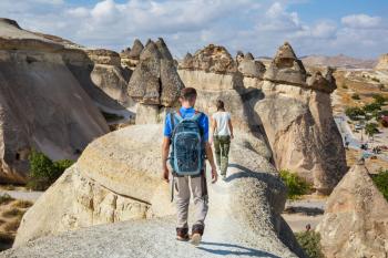 Tourist in Unusual rock formation in Cappadocia, Turkey