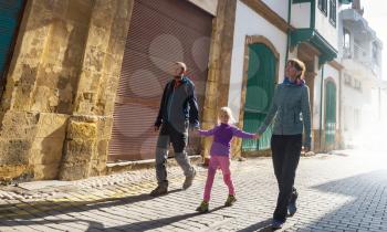 Family walking on the street in old european town