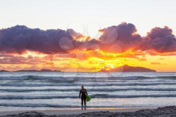 surfers on ocean  beach in New Zealand