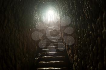 A dark tunnel toward light
