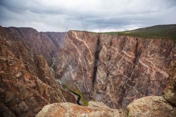 Tourist on the granite cliffs of the Black Canyon of the Gunnison, Colorado, USA