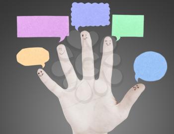 Happy group of finger smileys with social chat sign and speech thought. Fingers representing a social network.