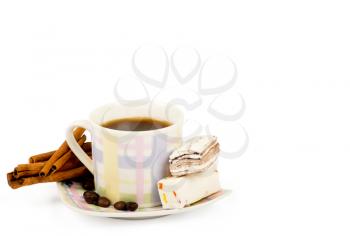 Coffee cup with sweets an cinnamon on white background