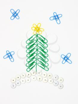 Christmas fur-tree from paper clips for a paper on a white background