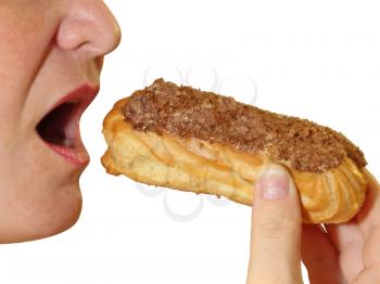 Close up of a young woman eating a cake eclair over white background.