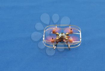 Drone quadcopter on the blue background.