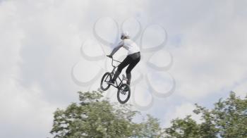 MOSCOW - JUNE 23: Jumping on trampoline with bike, extreme sports at slow motion on June 23, 2019 in Moscow, Russia