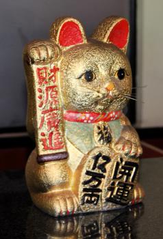 Royalty Free Photo of a Golden Welcome Cat Figurine