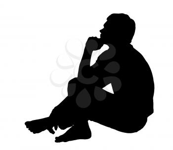 Side profile portrait silhouette of a teenage boy sitting on ground thinking 