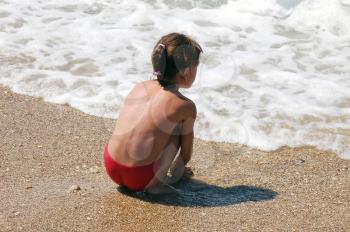 sea and child girl on beach