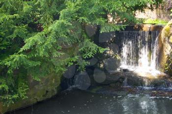waterfall with water which flows between stones