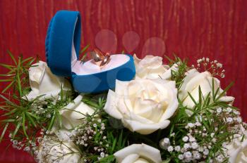 wedding rings in blue box and white rose