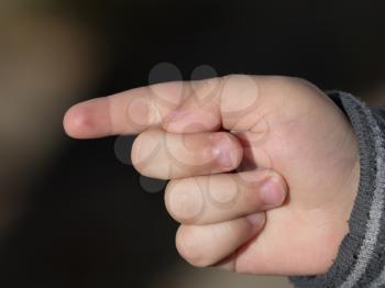 child's hand points a finger