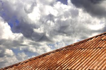 rusty roof and clouds in the background