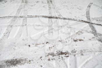 traces of cars on the road in winter