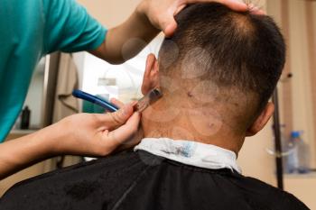 Fashionable men's haircut in a beauty salon .