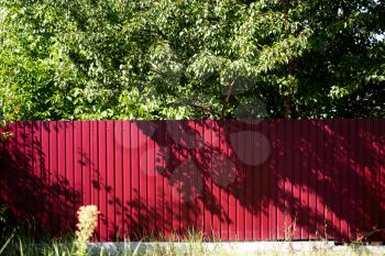 red fence made of metal in the garden .