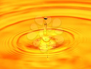 abstract background. A drop of water falls in gold