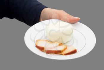 smoked bacon and onions in a plate on a gray background